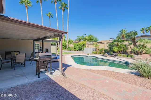 a swimming pool with outdoor seating and yard