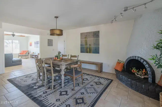 a dining room with a wooden table and chairs