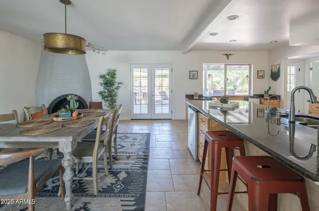 a kitchen with sink table and chairs