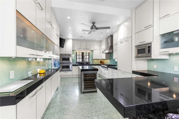 a large kitchen with stainless steel appliances lots of counter space