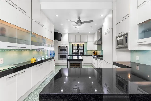 a kitchen with stainless steel appliances granite countertop a sink counter space and cabinets