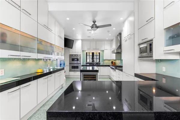 a kitchen with stainless steel appliances granite countertop a sink counter space and cabinets