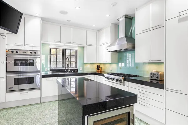 a kitchen with stainless steel appliances a stove a microwave and cabinets