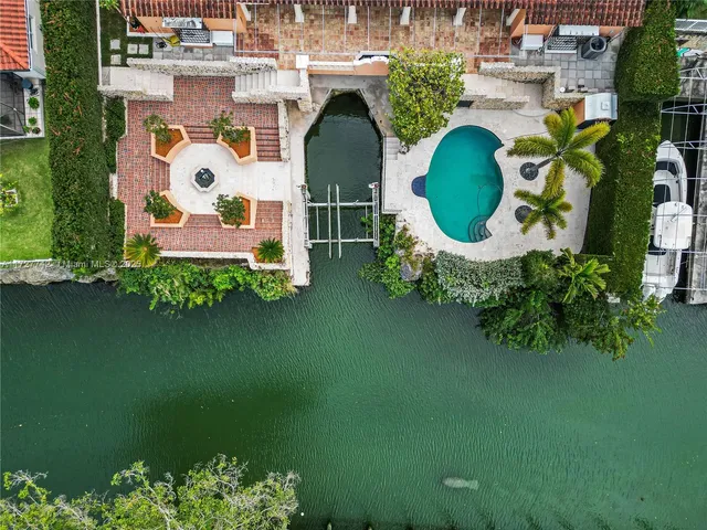 an aerial view of a house with outdoor space pool seating area and yard