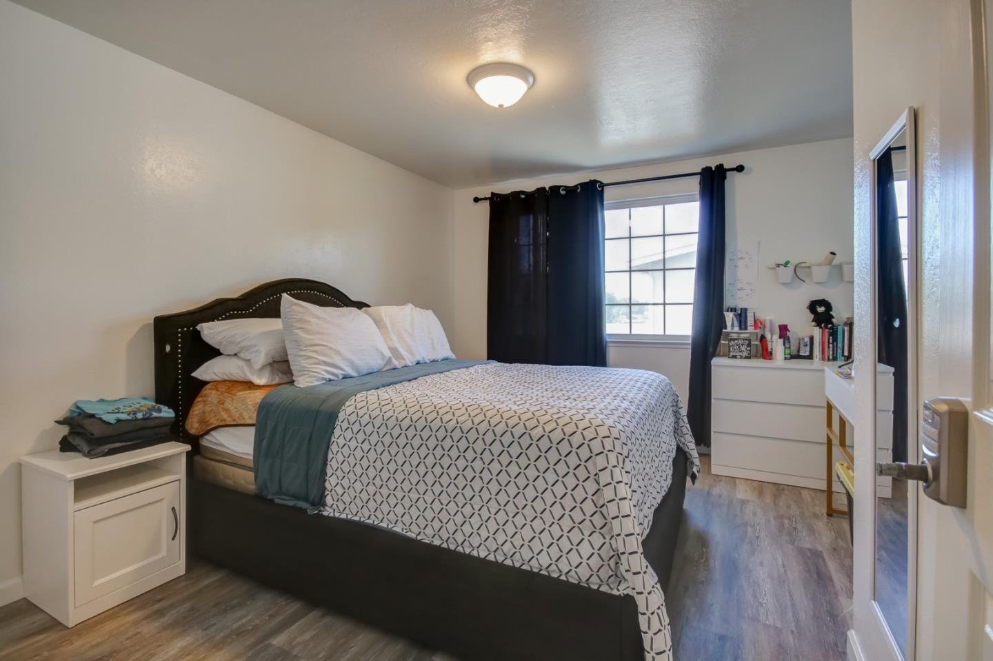1350 San Blanco Drive Salinas, CA 93901 - Photo 5 of 22 a bedroom with a bed and a dresser with wooden floor