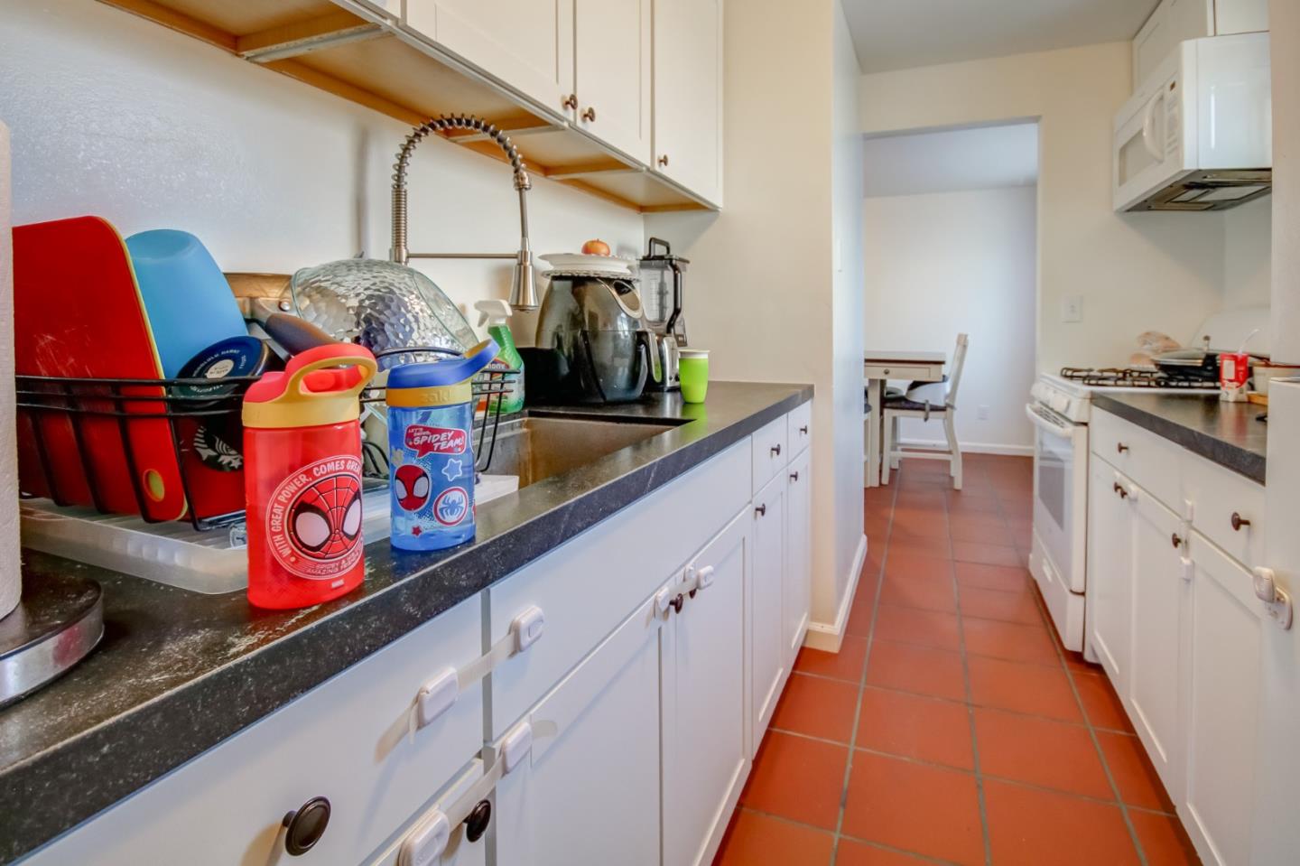 1350 San Blanco Drive Salinas, CA 93901 - Photo 10 of 22 a kitchen with stainless steel appliances granite countertop a sink and dishwasher a stove top oven with wooden floor