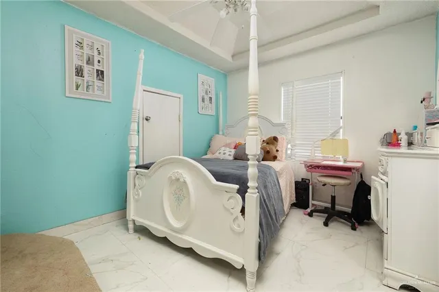 a bed room with a bed and a chair