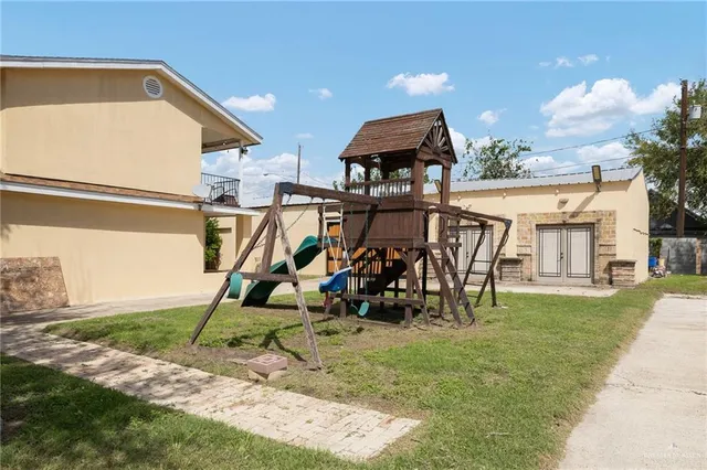 a view of a house with a swimming pool and a yard