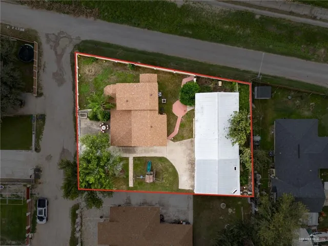 an aerial view of a house with a yard