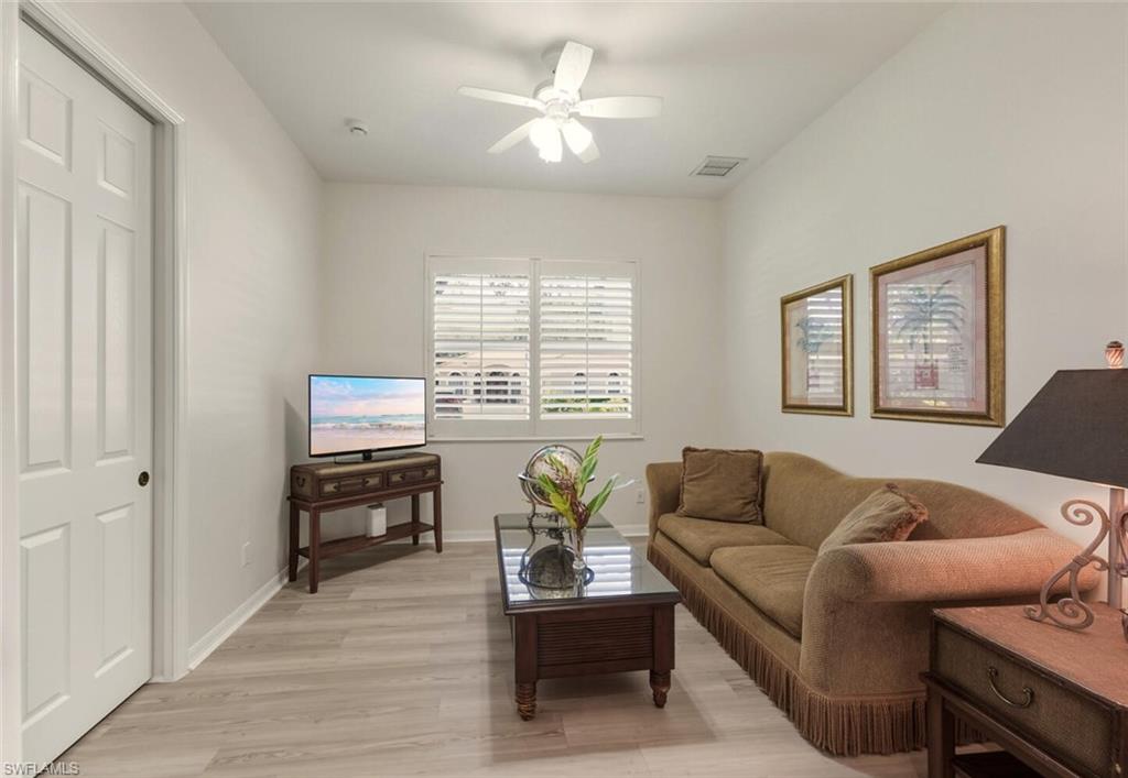 10800 Fieldfair Drive Naples, FL 34119 - Photo 15 of 47 Living room featuring light wood-type flooring and a ceiling fan