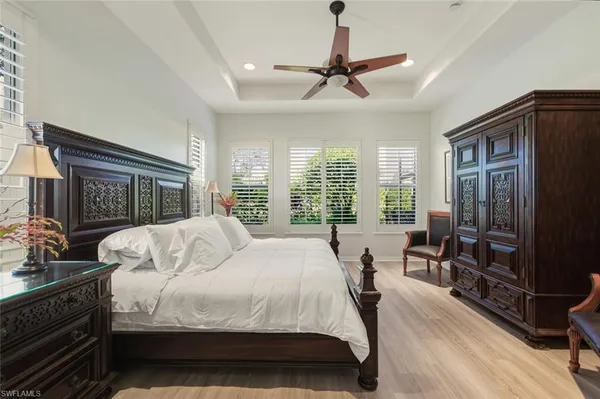 a large bedroom with a bed and a large window