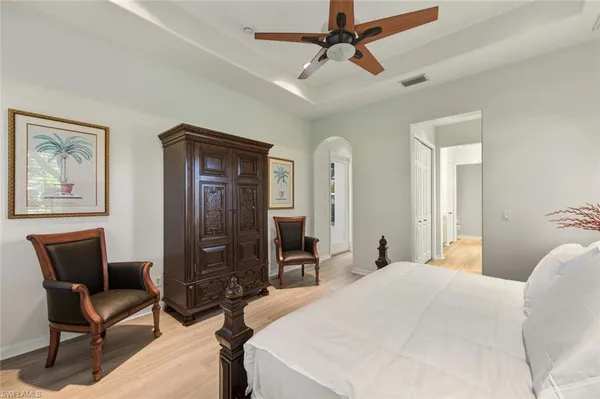 a bed sitting in a bedroom next to a window