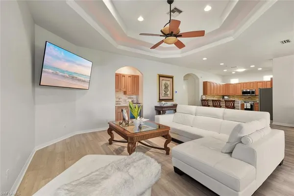 a living room with furniture and a ceiling fan