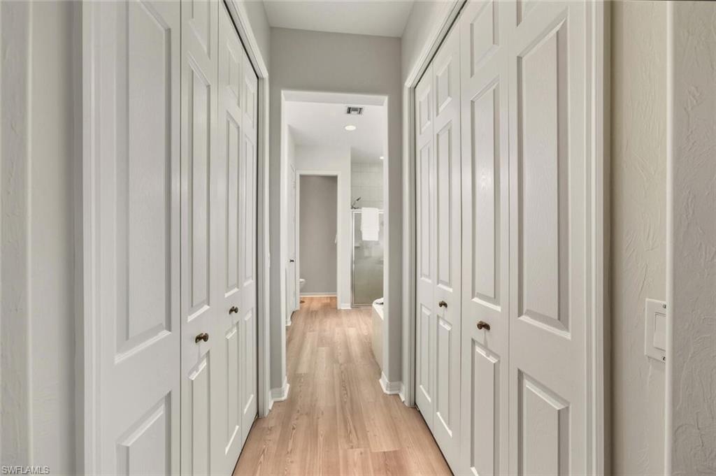 10800 Fieldfair Drive Naples, FL 34119 - Photo 20 of 47 Corridor with light wood-style floors and baseboards