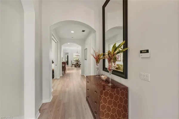 a hallway with wooden floor and glass door
