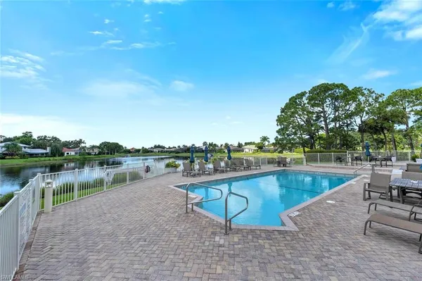 a view of swimming pool with outdoor seating and plants