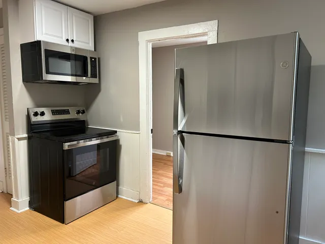 a kitchen with a refrigerator sink and microwave