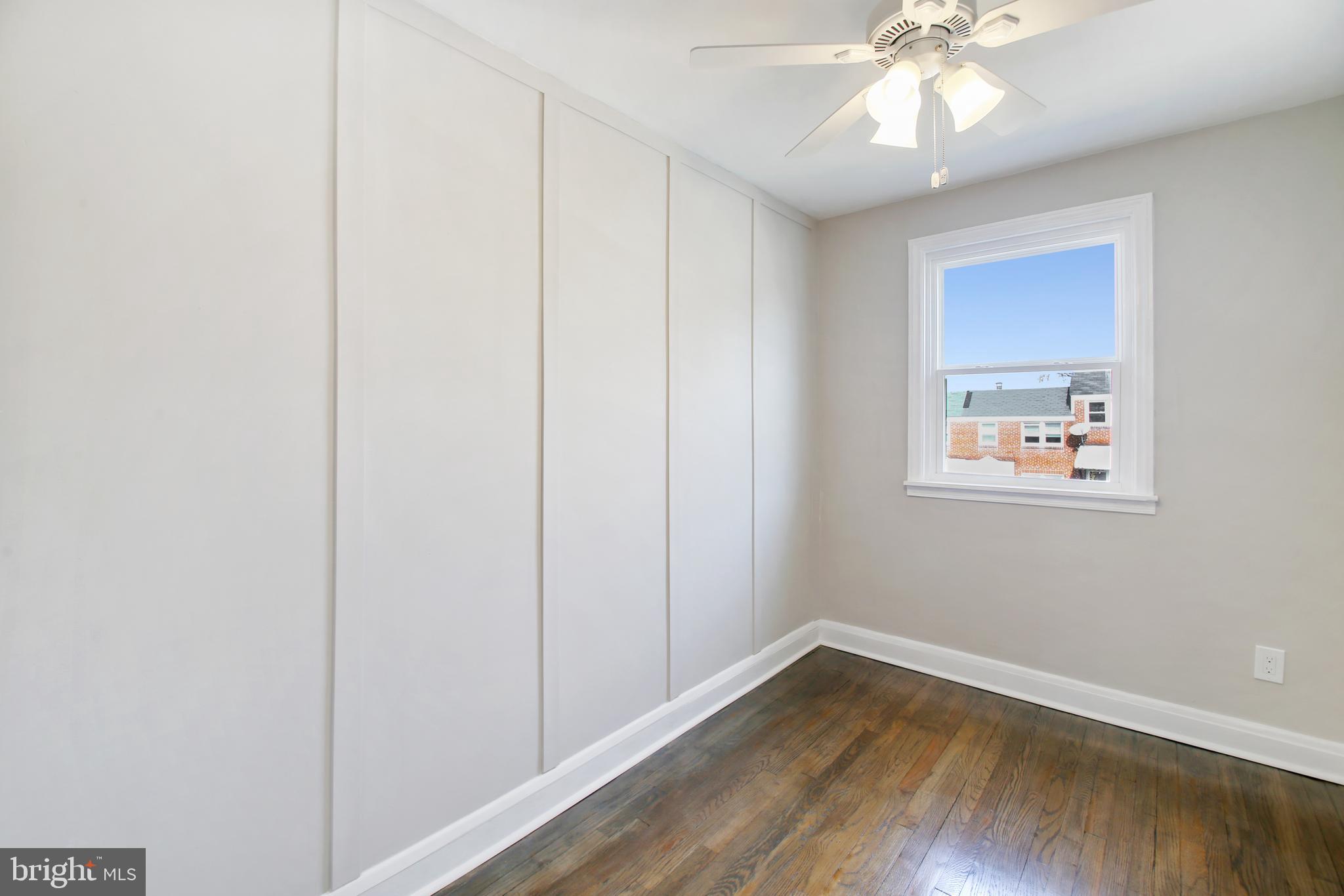 201 West Riverview Road Brooklyn, MD 21225 - Photo 29 of 35 4th Bedroom w/Accent Wall & Hardwood Flooring