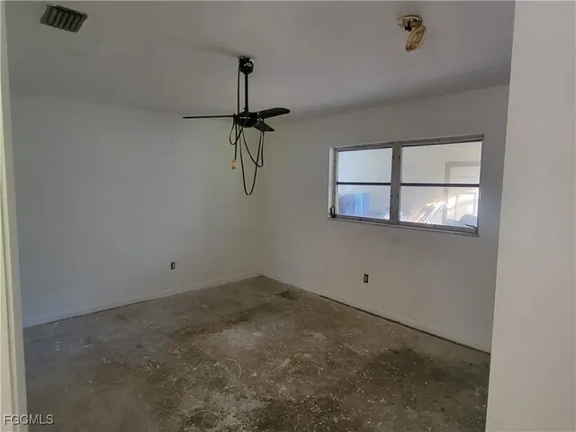 a view of a room with window and a ceiling fan