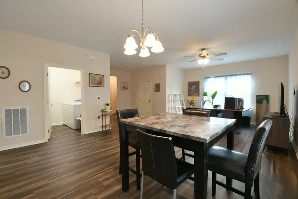 a view of a dining room with furniture and wooden floor