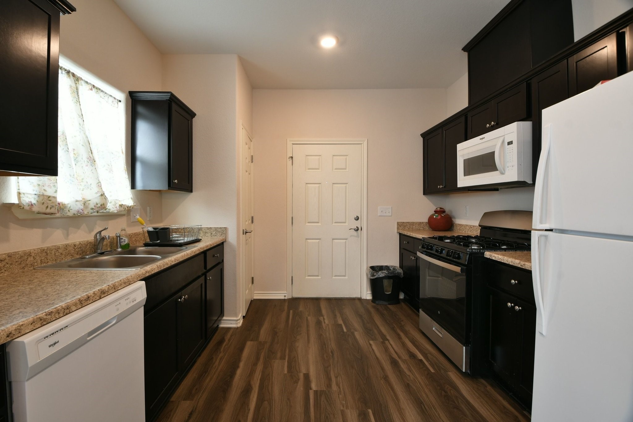 5817 Gaston Houston, TX 77016 - Photo 16 of 24 a kitchen with a refrigerator stove and sink