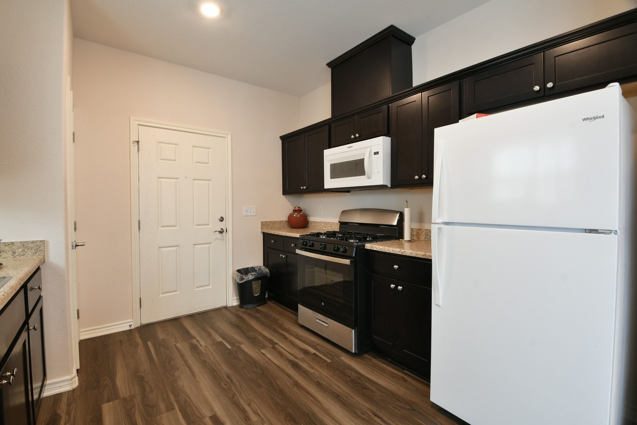 5817 Gaston Houston, TX 77016 - Photo 17 of 24 a kitchen with a refrigerator and a stove