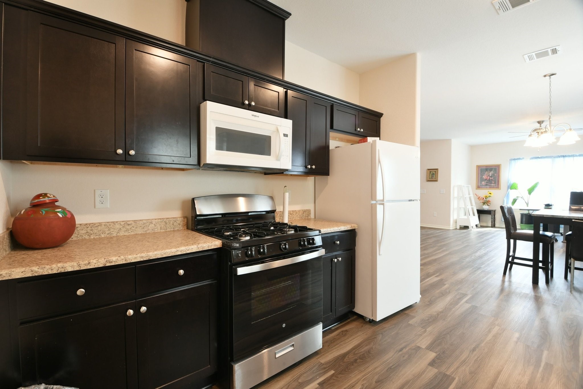5817 Gaston Houston, TX 77016 - Photo 18 of 24 a kitchen with a refrigerator and a stove top oven