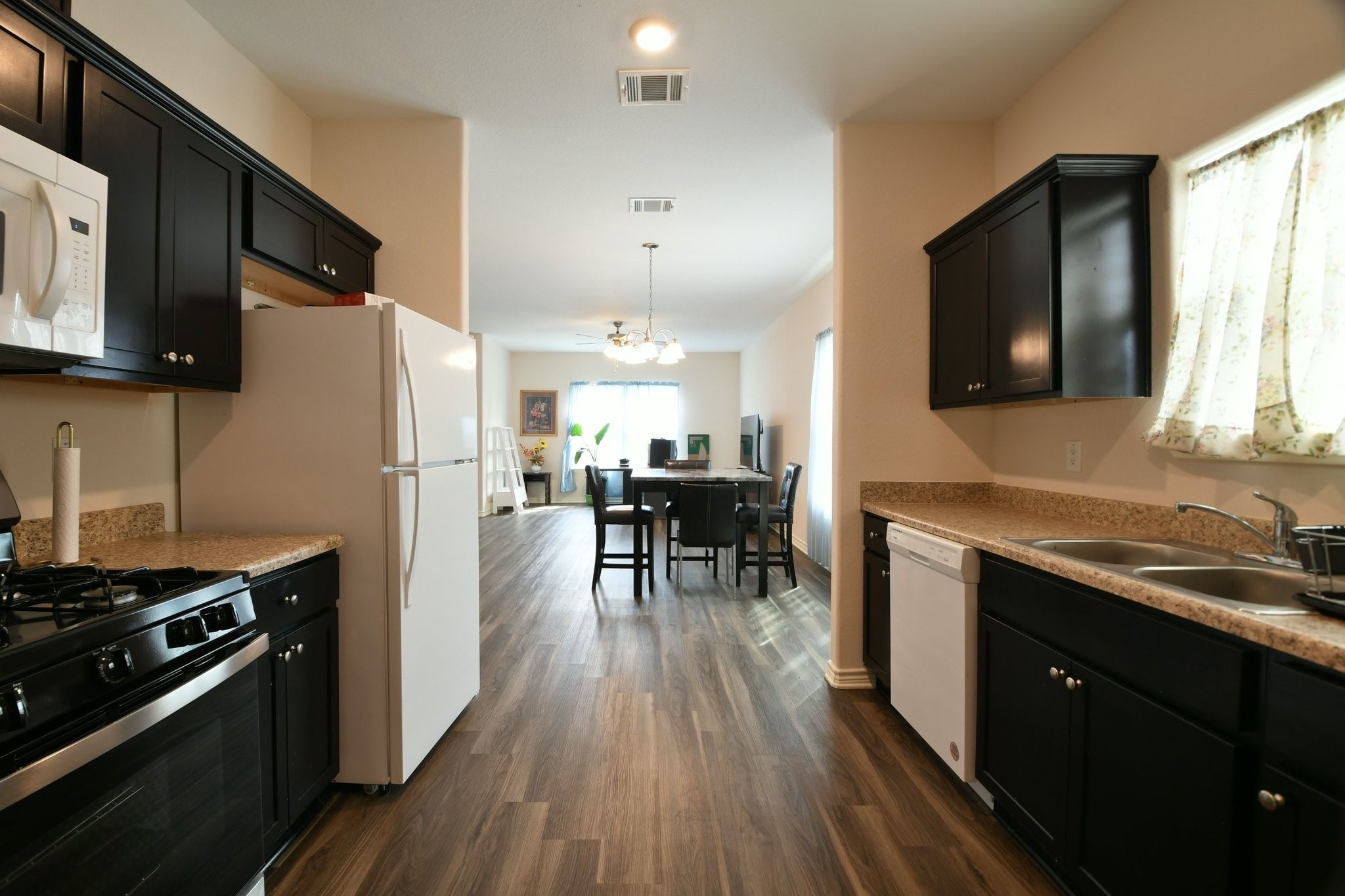 5817 Gaston Houston, TX 77016 - Photo 19 of 24 a kitchen with stainless steel appliances a stove a sink a refrigerator cabinets and dining table
