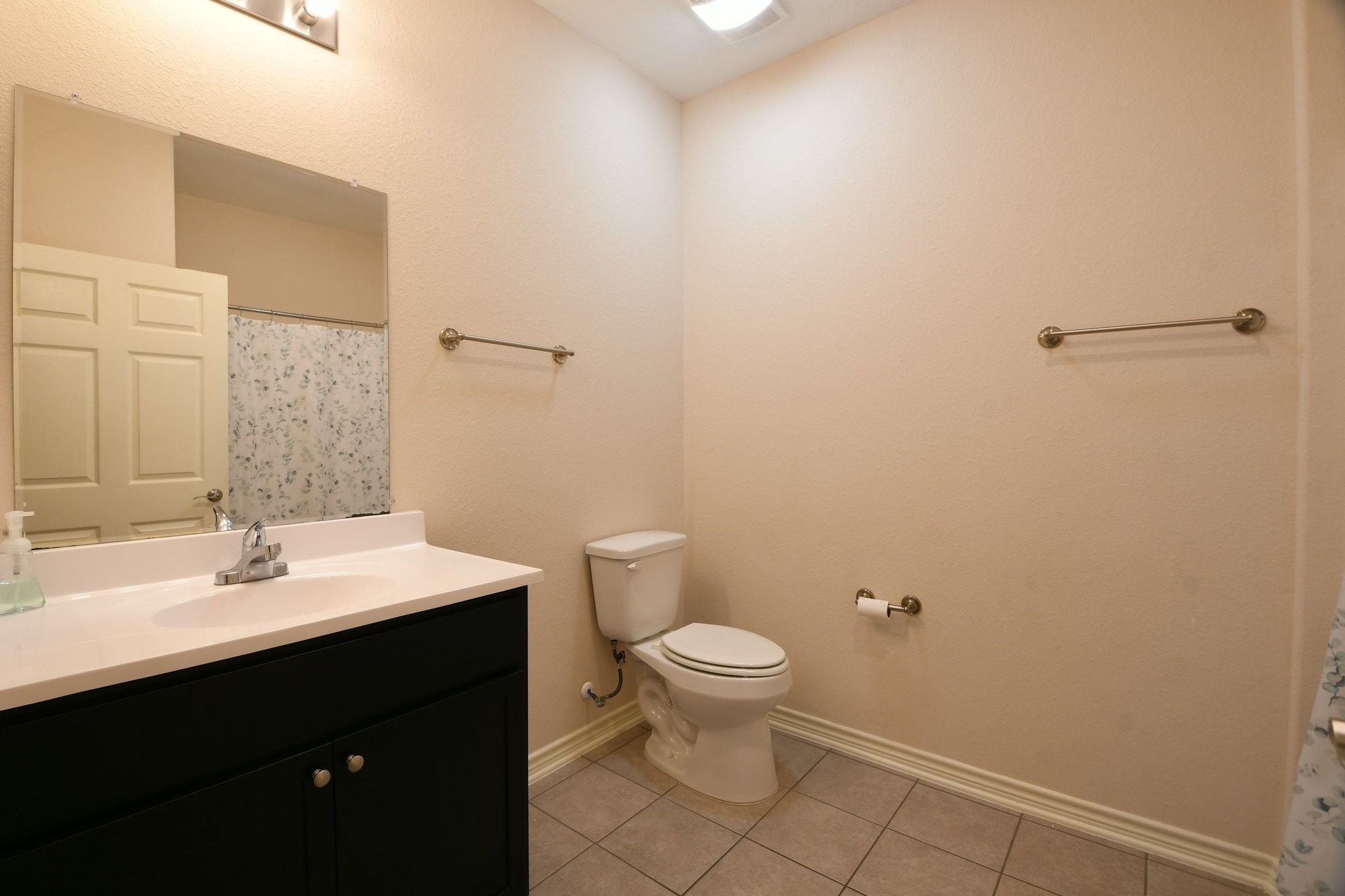 5817 Gaston Houston, TX 77016 - Photo 21 of 24 a bathroom with a sink a toilet and a mirror