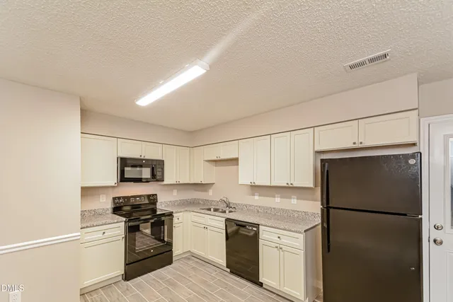 a kitchen with a refrigerator stove and microwave