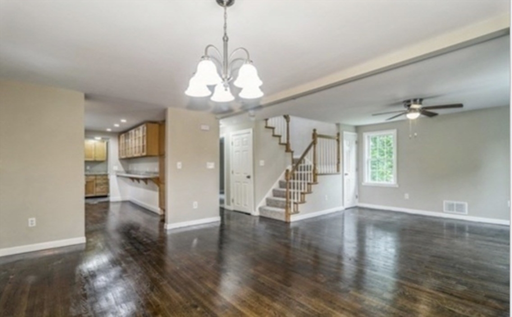 859 Pleasant Street Canton, MA 02021 - Photo 3 of 13 a view of a room with wooden floor chandelier and windows
