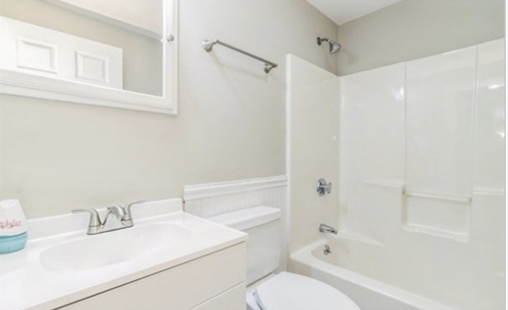 859 Pleasant Street Canton, MA 02021 - Photo 6 of 13 a bathroom with a sink toilet vanity and shower