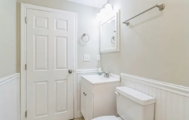 a bathroom with a sink a toilet and a mirror