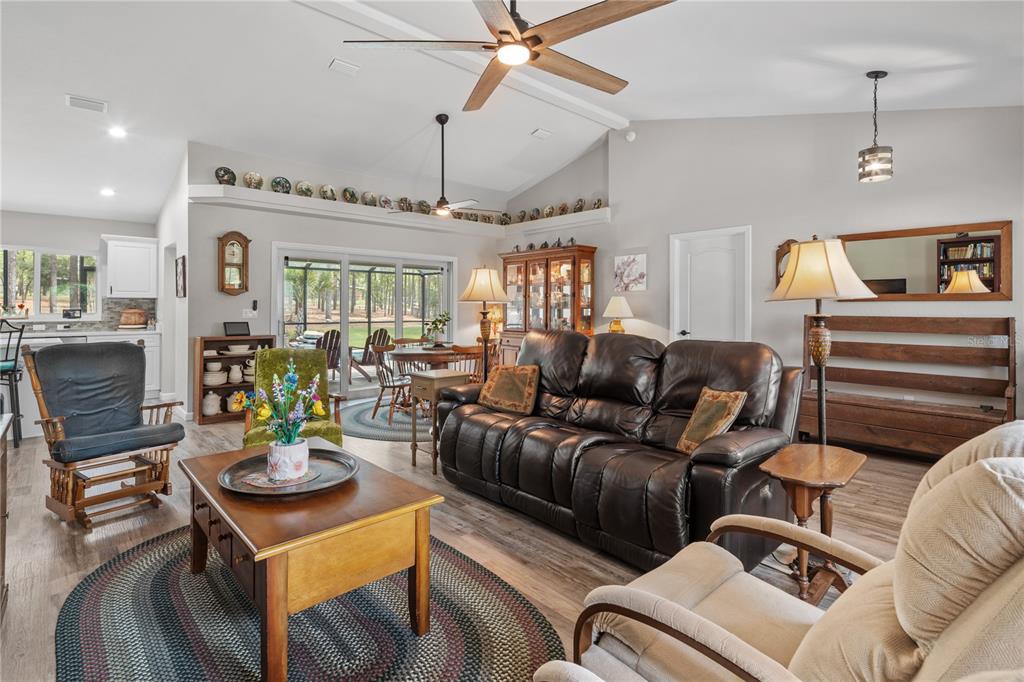 12929 Southwest 89th Street Dunnellon, FL 34432 - Photo 14 of 76 a living room with furniture and a chandelier