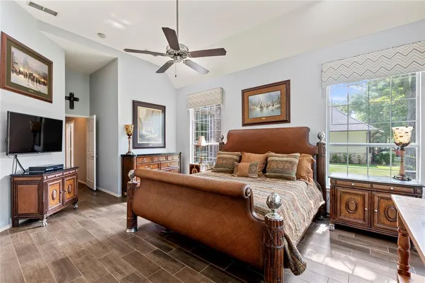 a bedroom with a bed and wooden floor