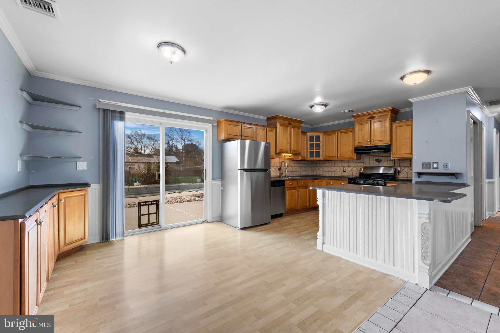 5 Fresno Street Barnegat, NJ 08005 - Photo 11 of 43 a kitchen with stainless steel appliances a refrigerator a stove top oven and a refrigerator