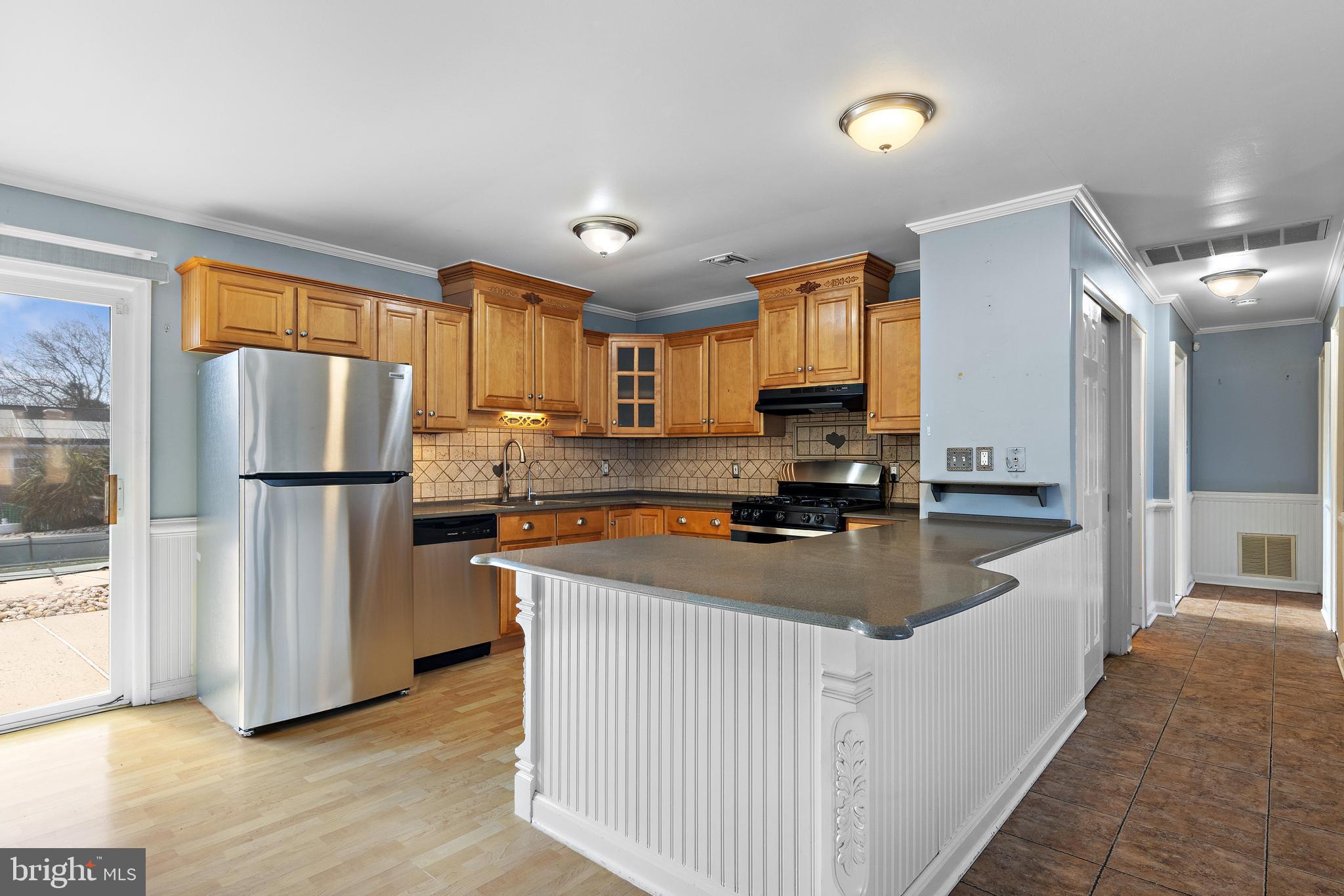 5 Fresno Street Barnegat, NJ 08005 - Photo 14 of 43 a kitchen with stainless steel appliances granite countertop a refrigerator a stove a sink and a refrigerator