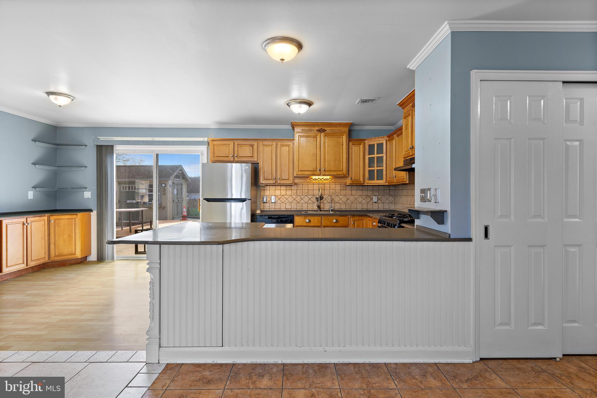 5 Fresno Street Barnegat, NJ 08005 - Photo 15 of 43 a kitchen with kitchen island granite countertop a stove and a view of living room