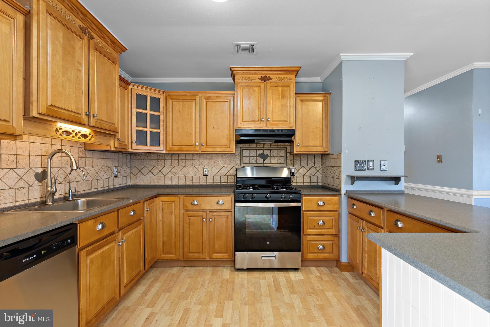 5 Fresno Street Barnegat, NJ 08005 - Photo 16 of 43 a kitchen with stainless steel appliances granite countertop a stove a sink and a microwave