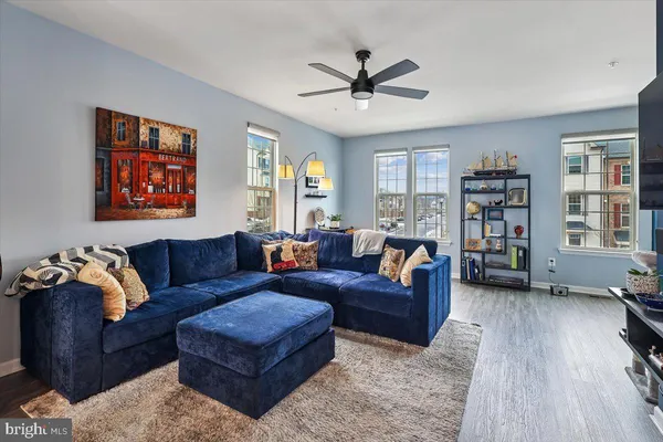 a living room with furniture and a book shelf