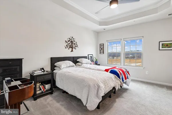 a spacious bedroom with a bed and a window
