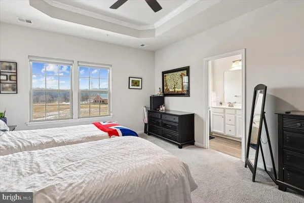 a bedroom with a bed dresser and a flat tv screen