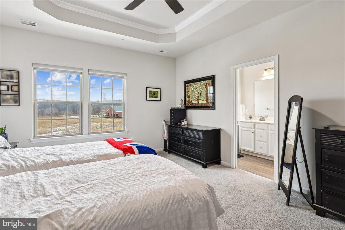 7838 Mine Run Road Hanover, MD 21076 - Photo 16 of 30 a bedroom with a bed dresser and a flat tv screen