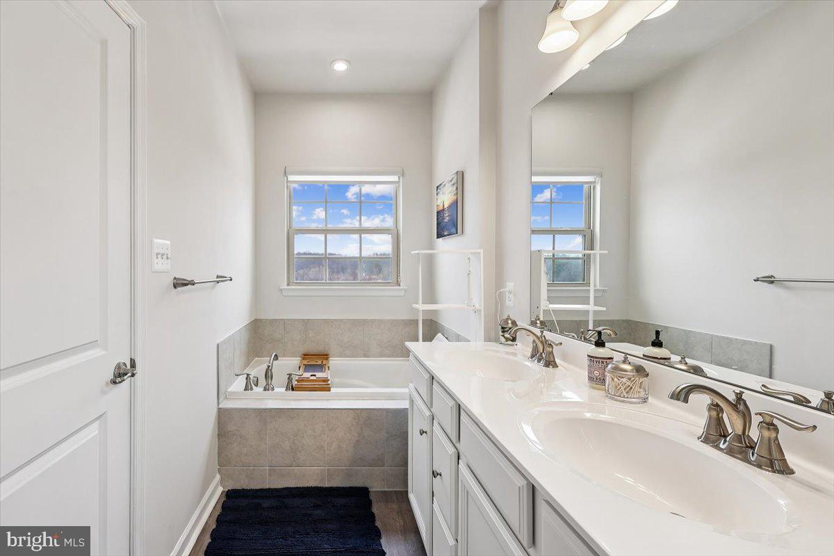 7838 Mine Run Road Hanover, MD 21076 - Photo 18 of 30 a bathroom with a tub sink and mirror