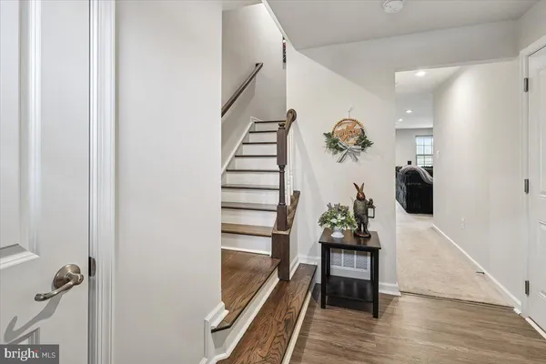 a view of entryway and hall with wooden floor