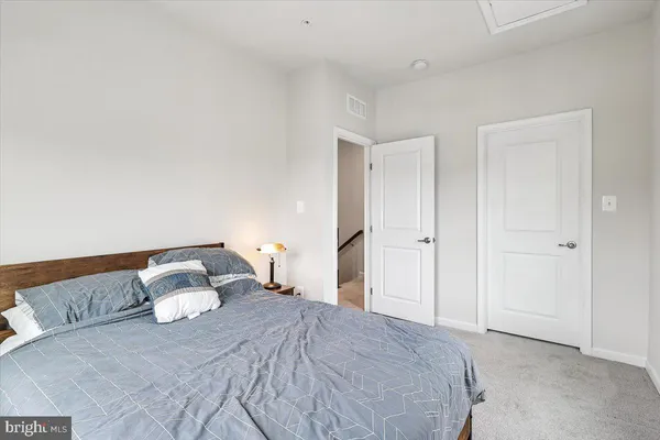 a bedroom with a bed and a night stand