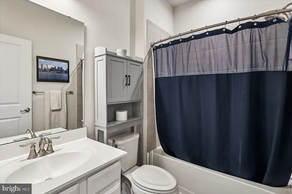 a bathroom with a sink a toilet a shower and a mirror