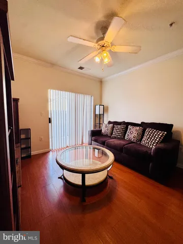 a kitchen with stainless steel appliances kitchen island granite countertop a refrigerator a stove and a microwave with wooden floor