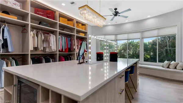 a view of kitchen island with cabinets and wooden floor