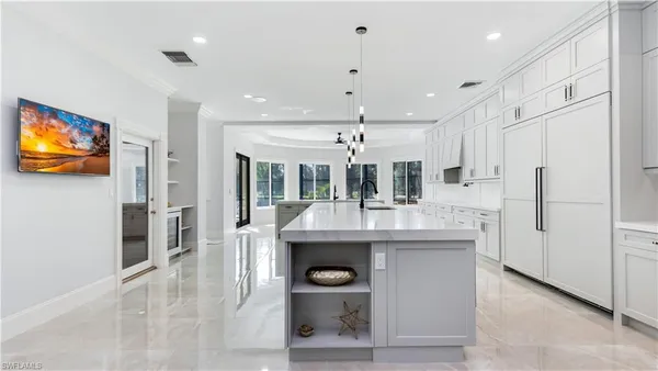 a kitchen with stainless steel appliances kitchen island granite countertop a refrigerator and a stove